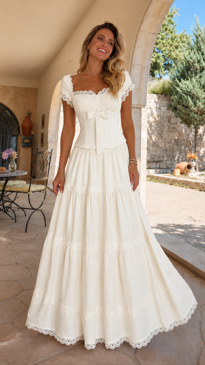 Front view of ivory lace trim bow front tiered maxi dress