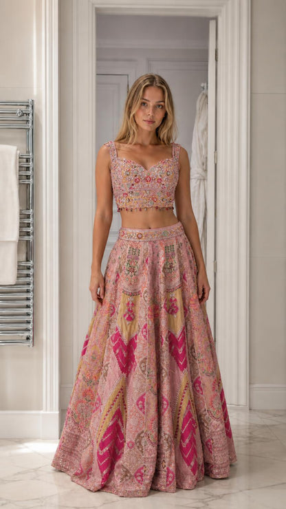 Woman wearing pink embroidered crop top and lehenga skirt set