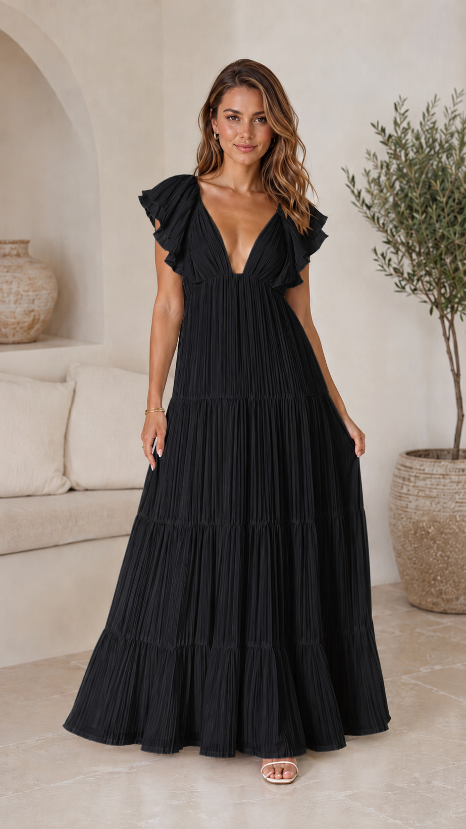 Full front view of black flutter sleeve pleated tiered maxi dress