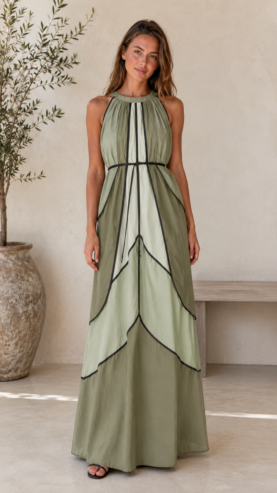 Front view of sage green halter maxi dress with black contrast trim