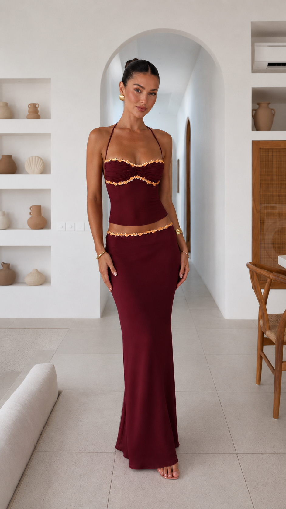 Front view of burgundy floral trim halter top and maxi skirt set