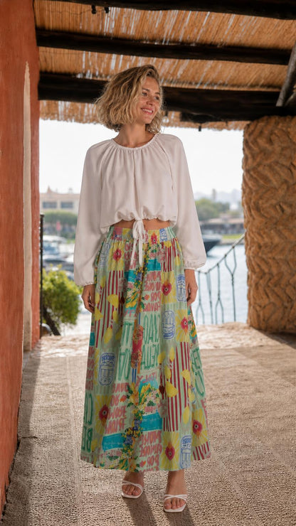Model wearing white crop top and green multi printed maxi skirt