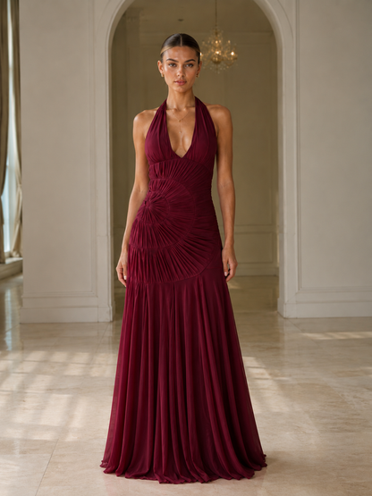 Front view of burgundy halter maxi gown with fitted bodice and flared hem