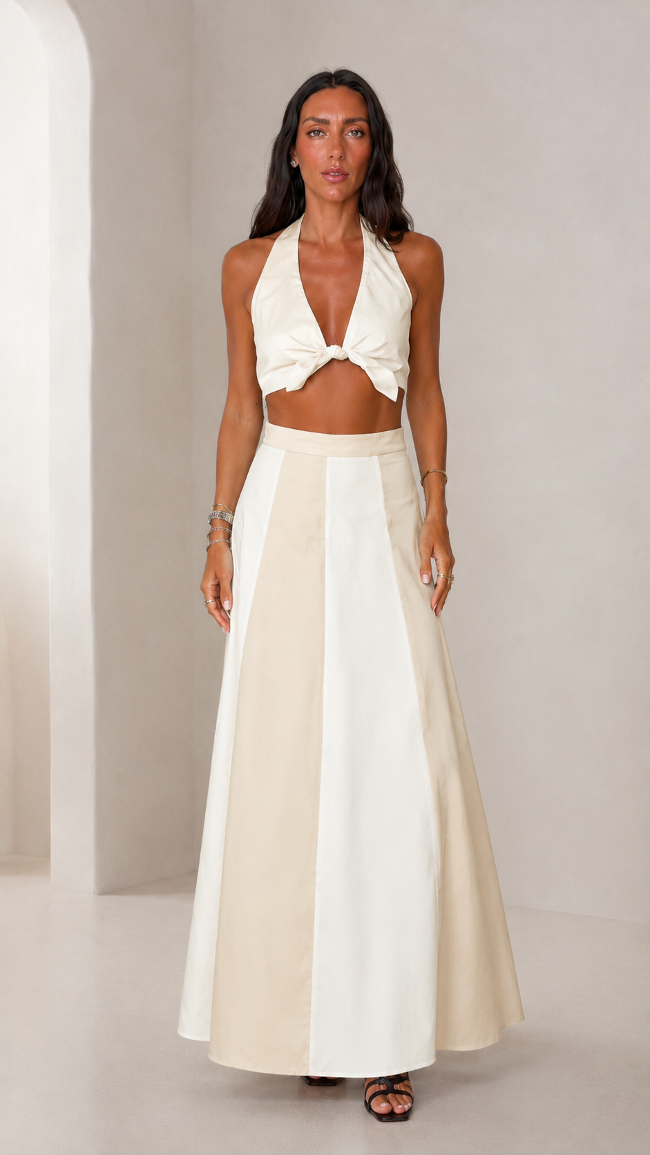 Front view of cream halter crop top and matching maxi skirt set