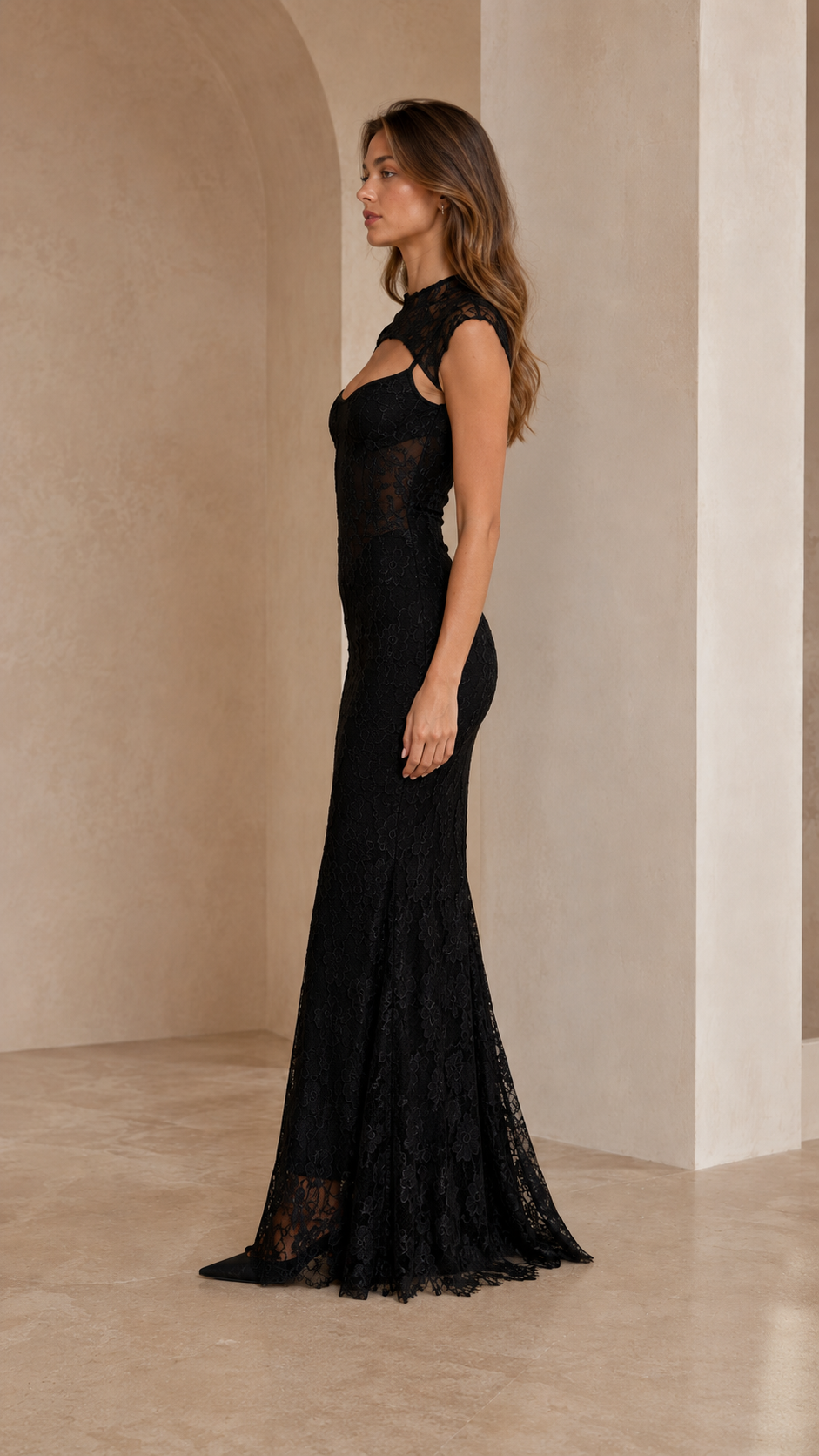 Side view of black lace mermaid gown with floor-length flared hem