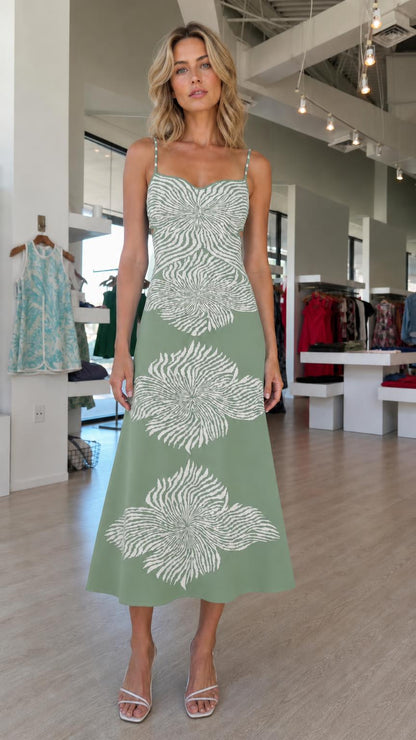 Model wearing green knit midi dress with white abstract floral motifs
