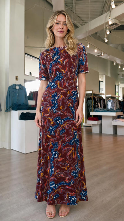 Front view of model wearing burgundy abstract print maxi dress