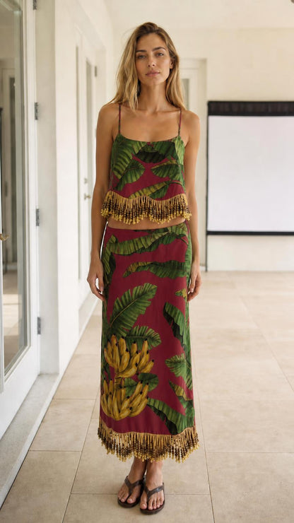 Model wearing burgundy color variant of the tropical leaf print two-piece set