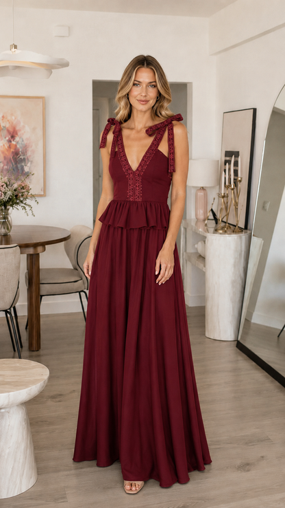 Front view of burgundy tie shoulder maxi dress with deep V neckline and tiered detail