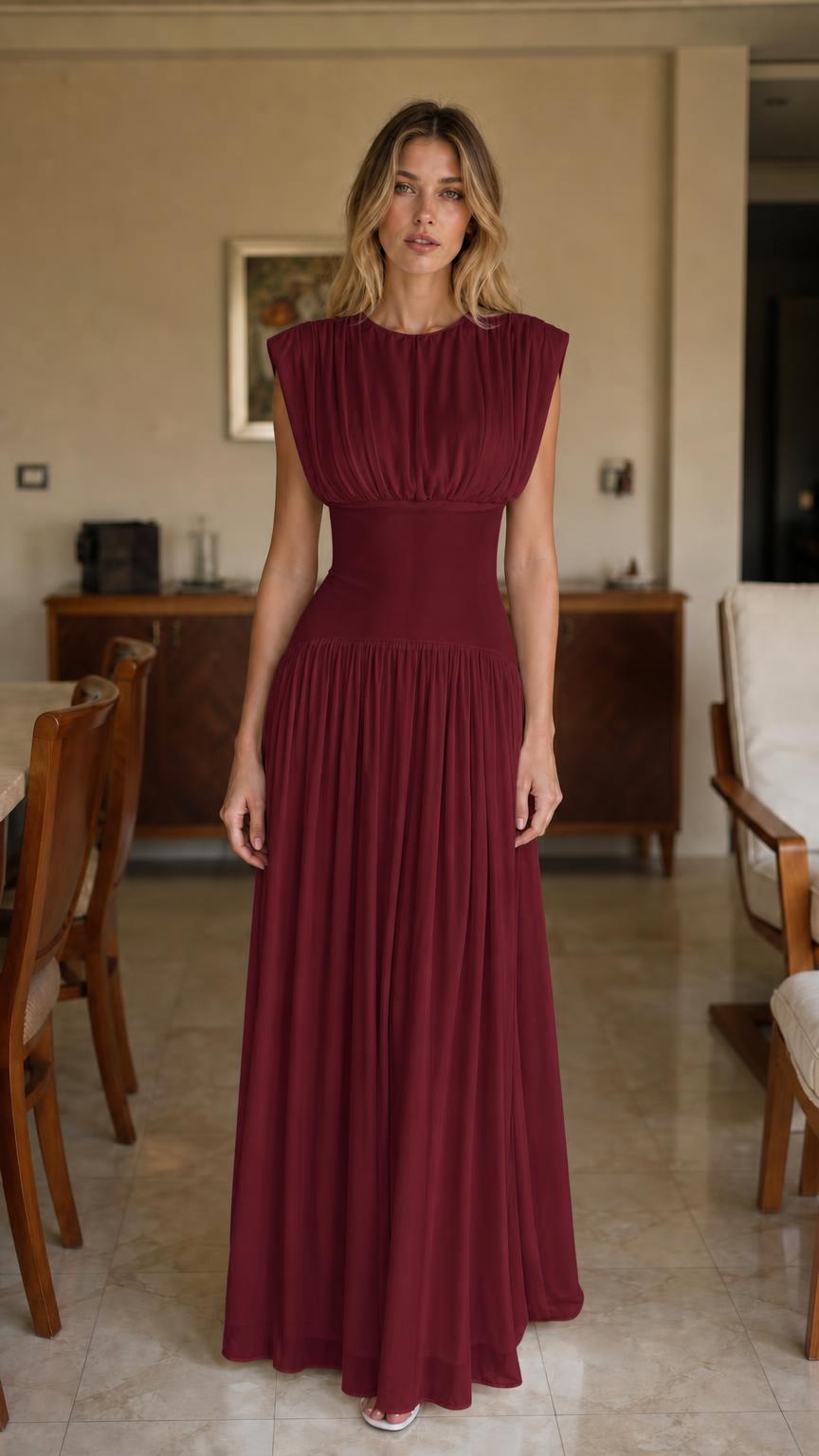 Front view of woman wearing burgundy pleated maxi dress