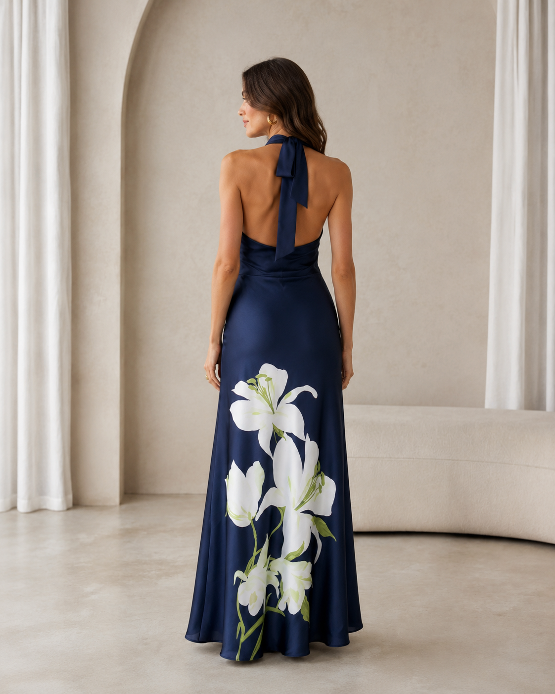Back view of navy halter maxi dress with open back and neck tie