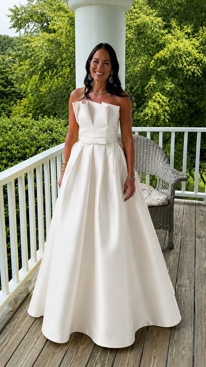 Front view of white strapless structured formal maxi gown