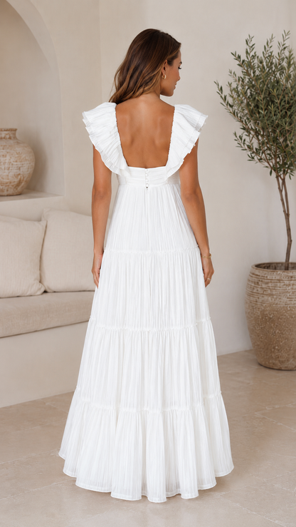 Back view of white pleated tiered maxi dress with low square back