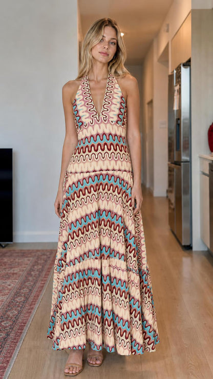Model wearing beige multi wave pattern halter maxi dress