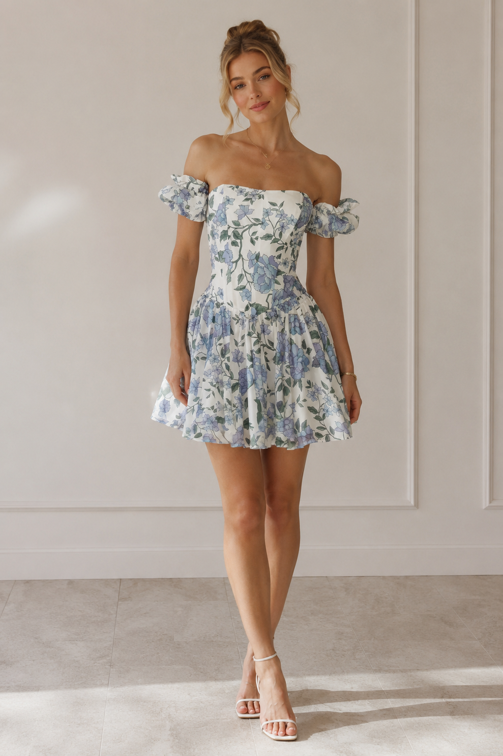 Full body image of sky blue floral off shoulder mini dress styled with heels